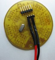 The positive terminal goes to the leftmost pin of the shorter connector, the negative terminal to the middle one of the remaining three pins.